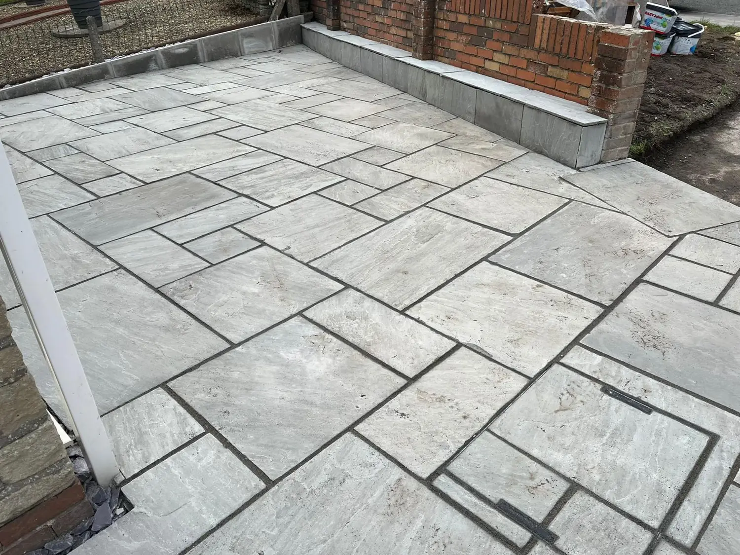 Grey Indian sandstone patio recently completed by Imperial Gardens